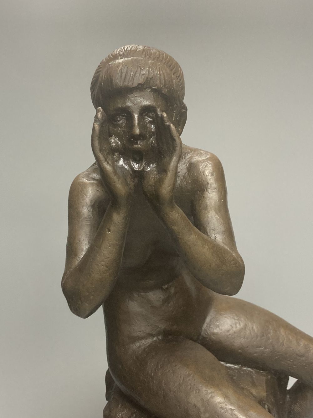 A bronze model of a seated female nude, indistinctly signed Silk, on marble plinth, 52cm